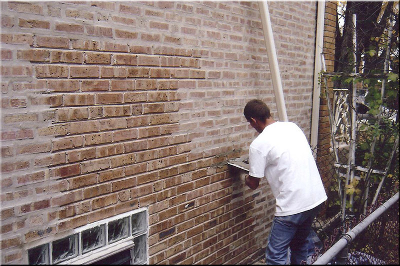 Bricklayer during wall restoration