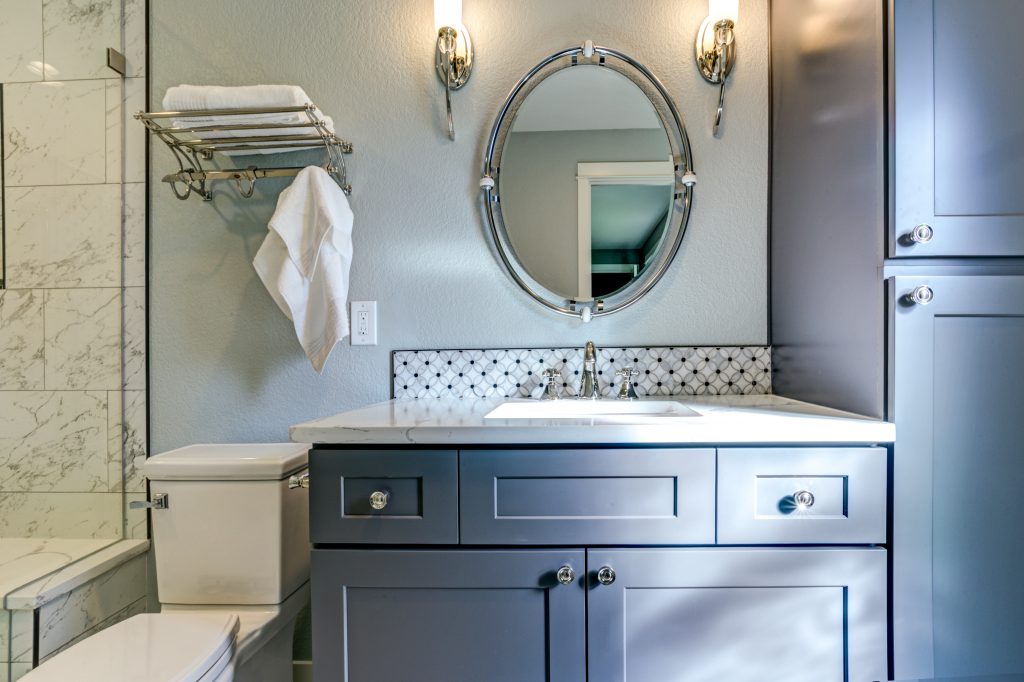 New blue bathroom design with Marble shower Surround and mosaic accent tiles.